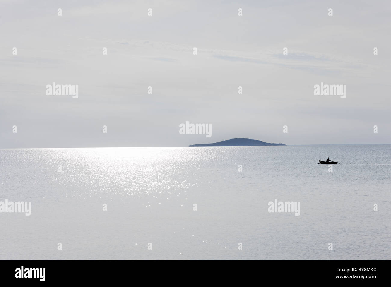 View of sea with boat in distance Stock Photo - Alamy