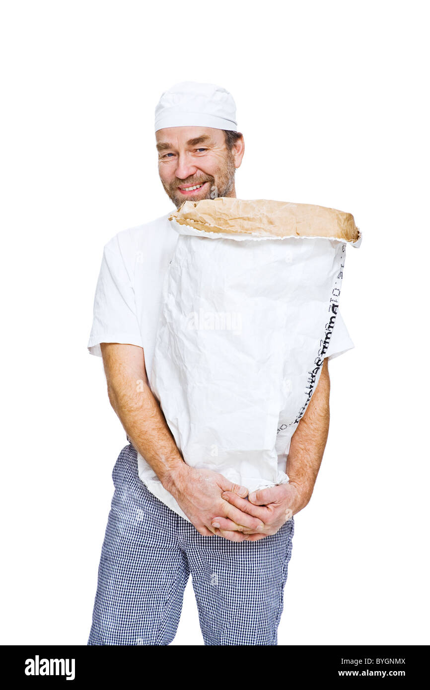 Studio portrait of male baker holding sack Stock Photo