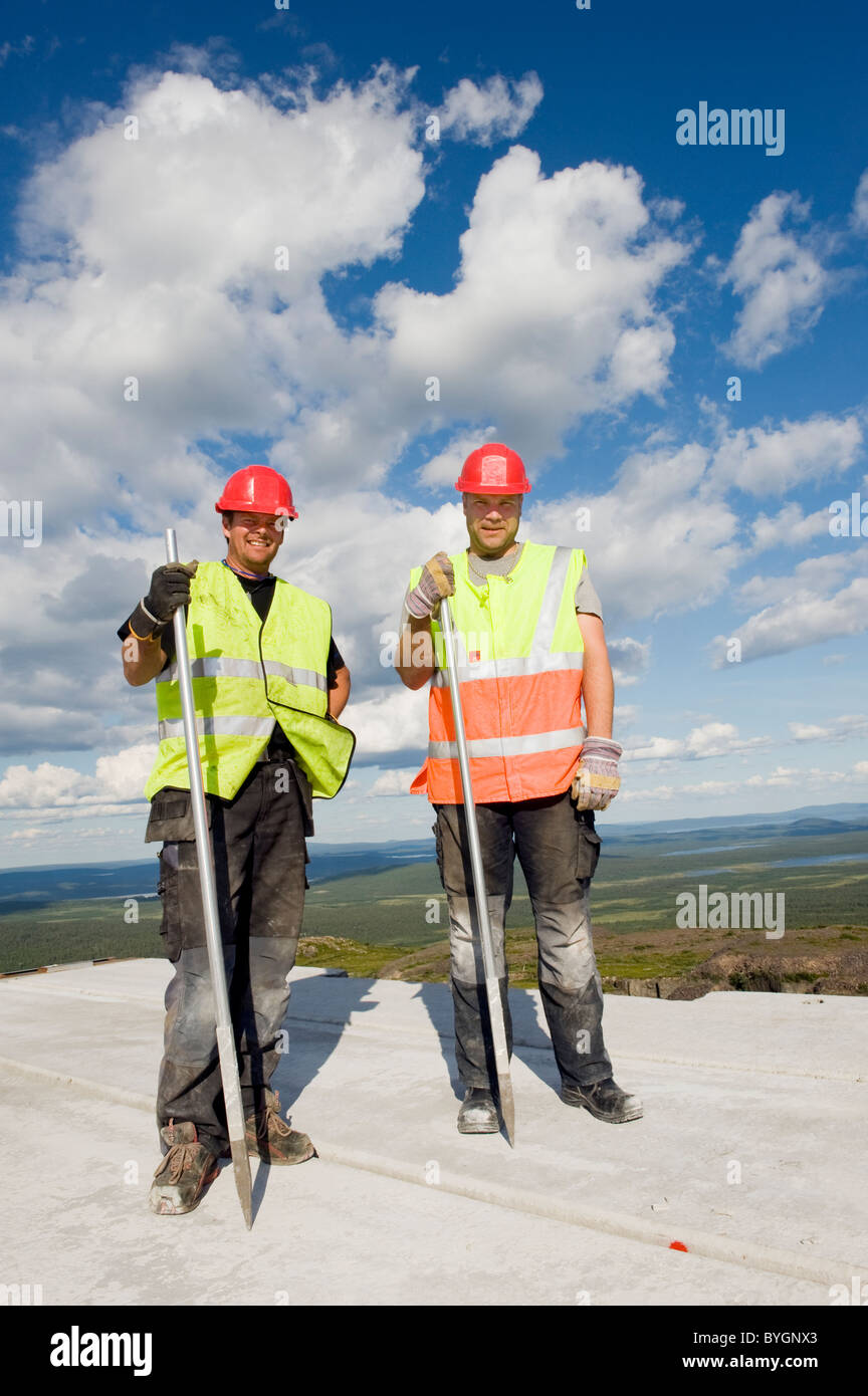 Workers standing on concrete at construction site Stock Photo Alamy