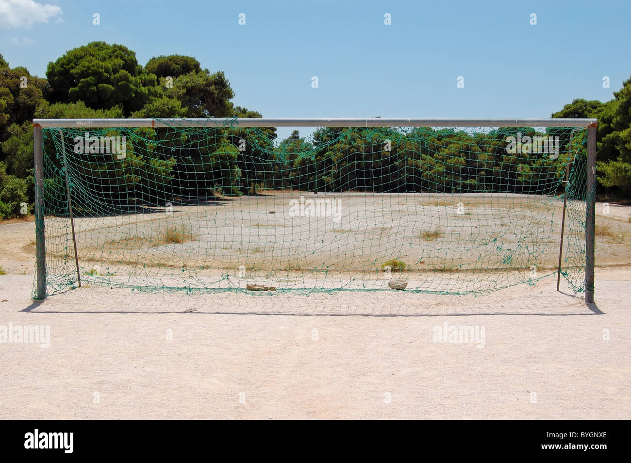 Empty soccer goalpost pitch and net in a park. Stock Photo