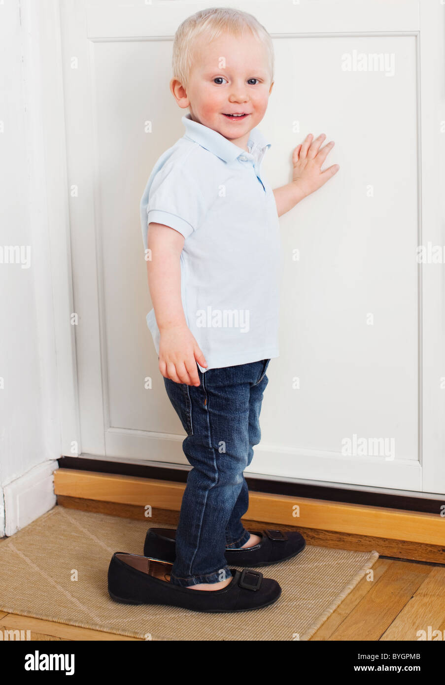 Portrait of boy wearing womens shoes Stock Photo