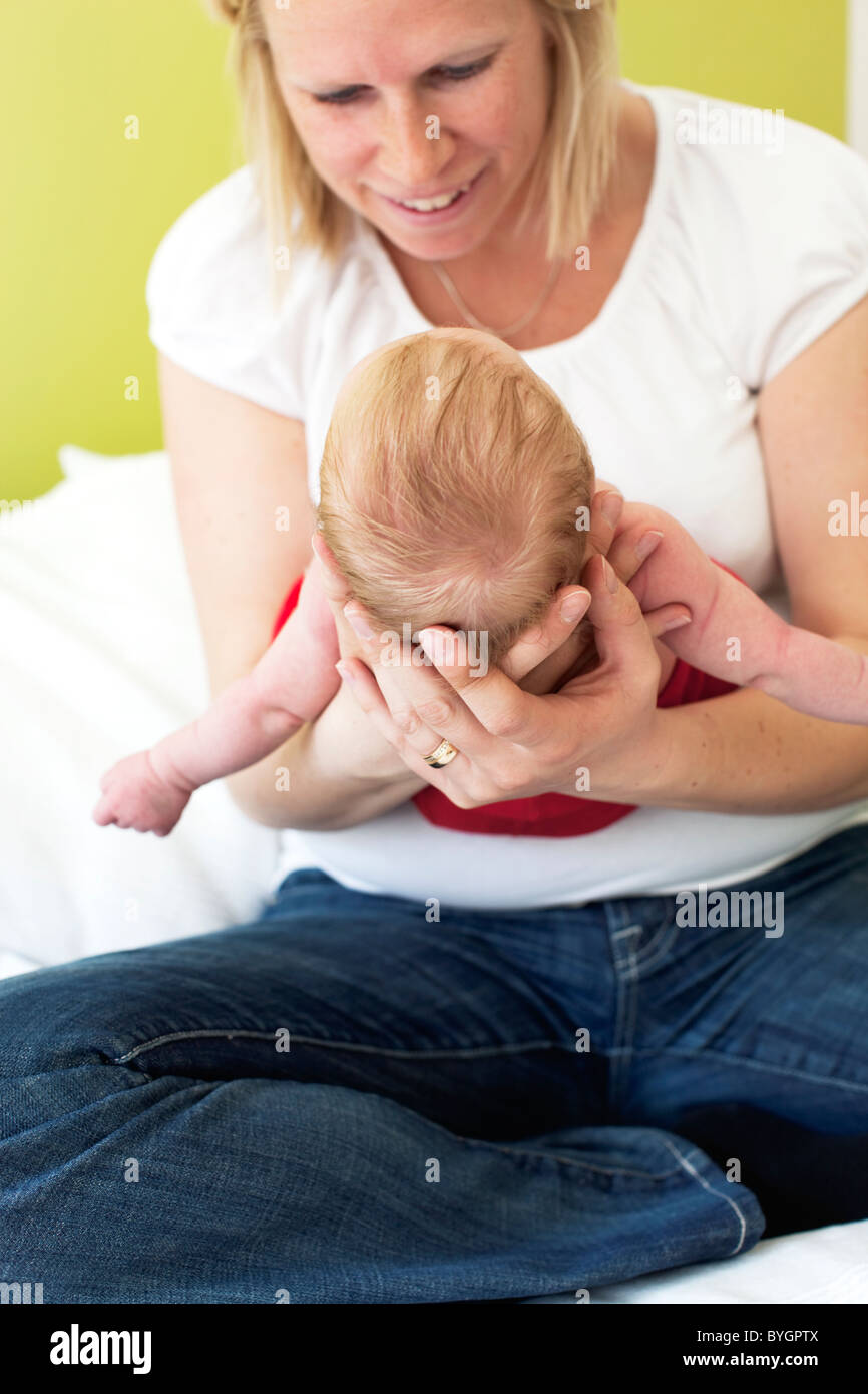 Woman carries baby babies hi-res stock photography and images - Alamy