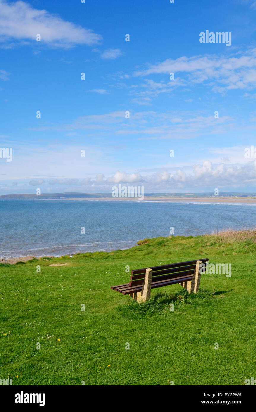 A bench overlooking Bideford Bay at Westward Ho! on the North Devon coast, England. Stock Photo