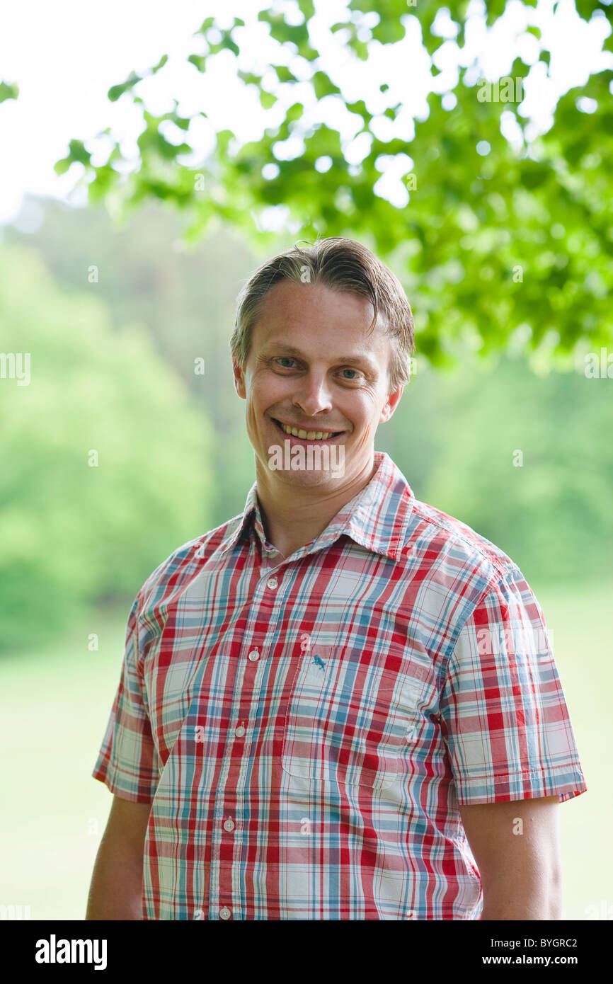 Portrait of young man smiling Stock Photo - Alamy