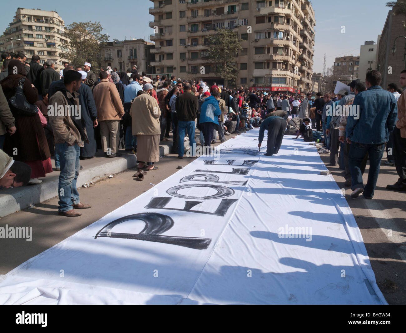 protestors painting sign in Tahrir Square, Cairo, Egypt saying People demand removal of the regime Stock Photo