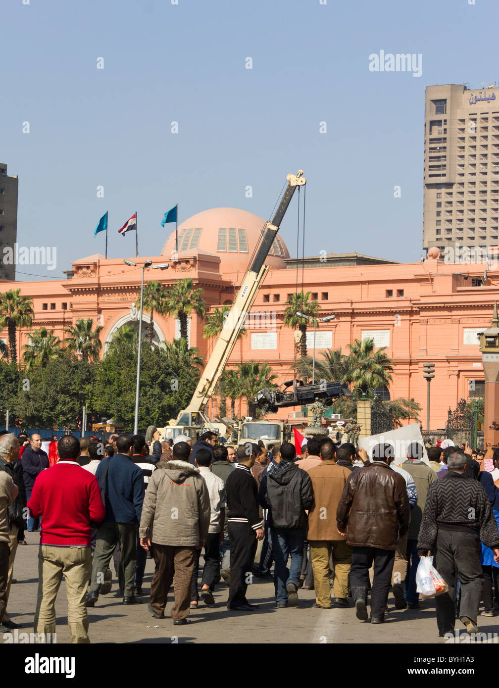 army crane removing burnt out police van in front of the Egyptian Museum, Tahrir Square, Cairo, Egypt Stock Photo