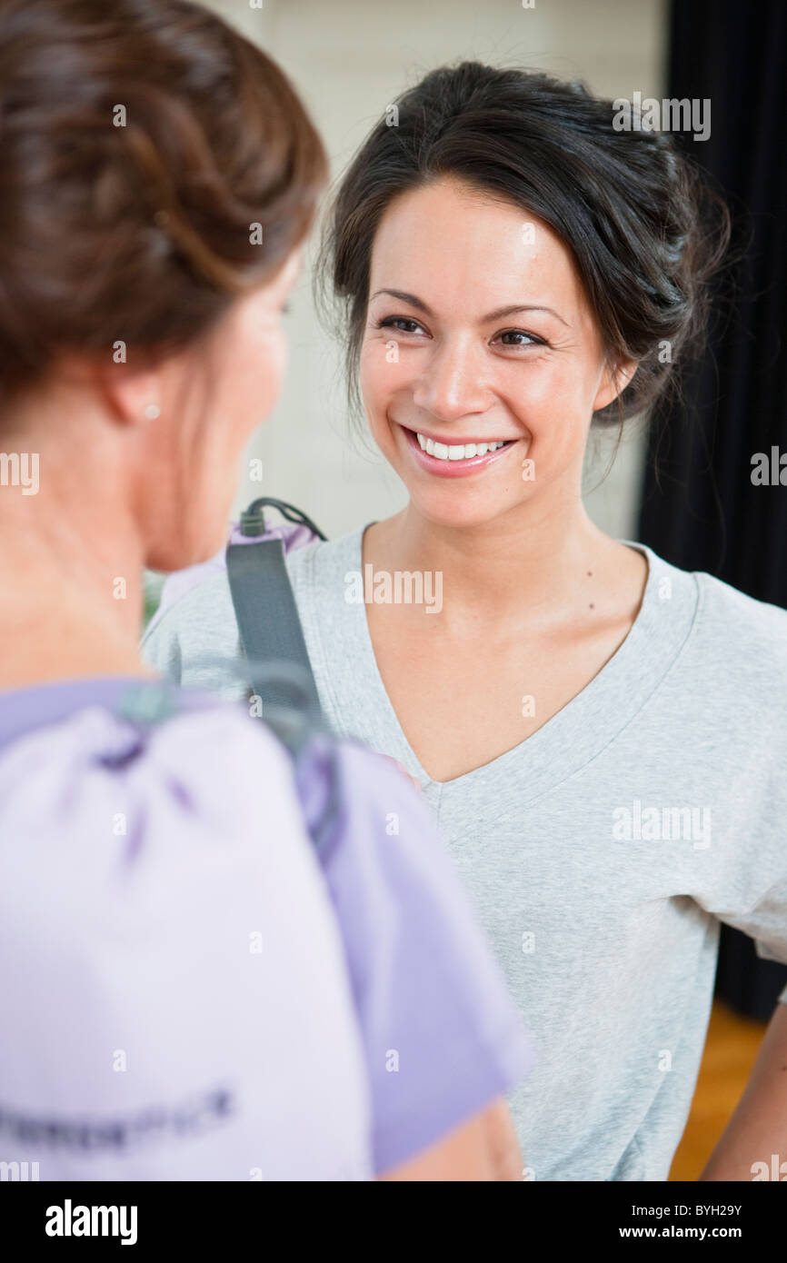Two women smiling, indoors Stock Photo