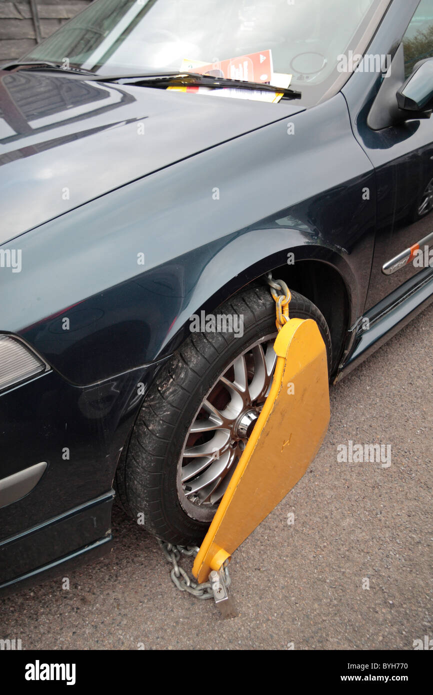 A wheel clamp on a car in a private car park in Hounslow, UK Stock