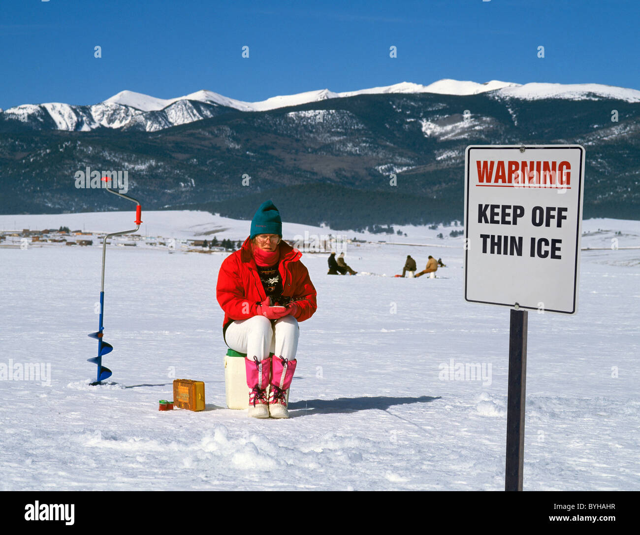 A woman ice fishing on a dangerous lake, Eagle Nest Lake, New Mexico