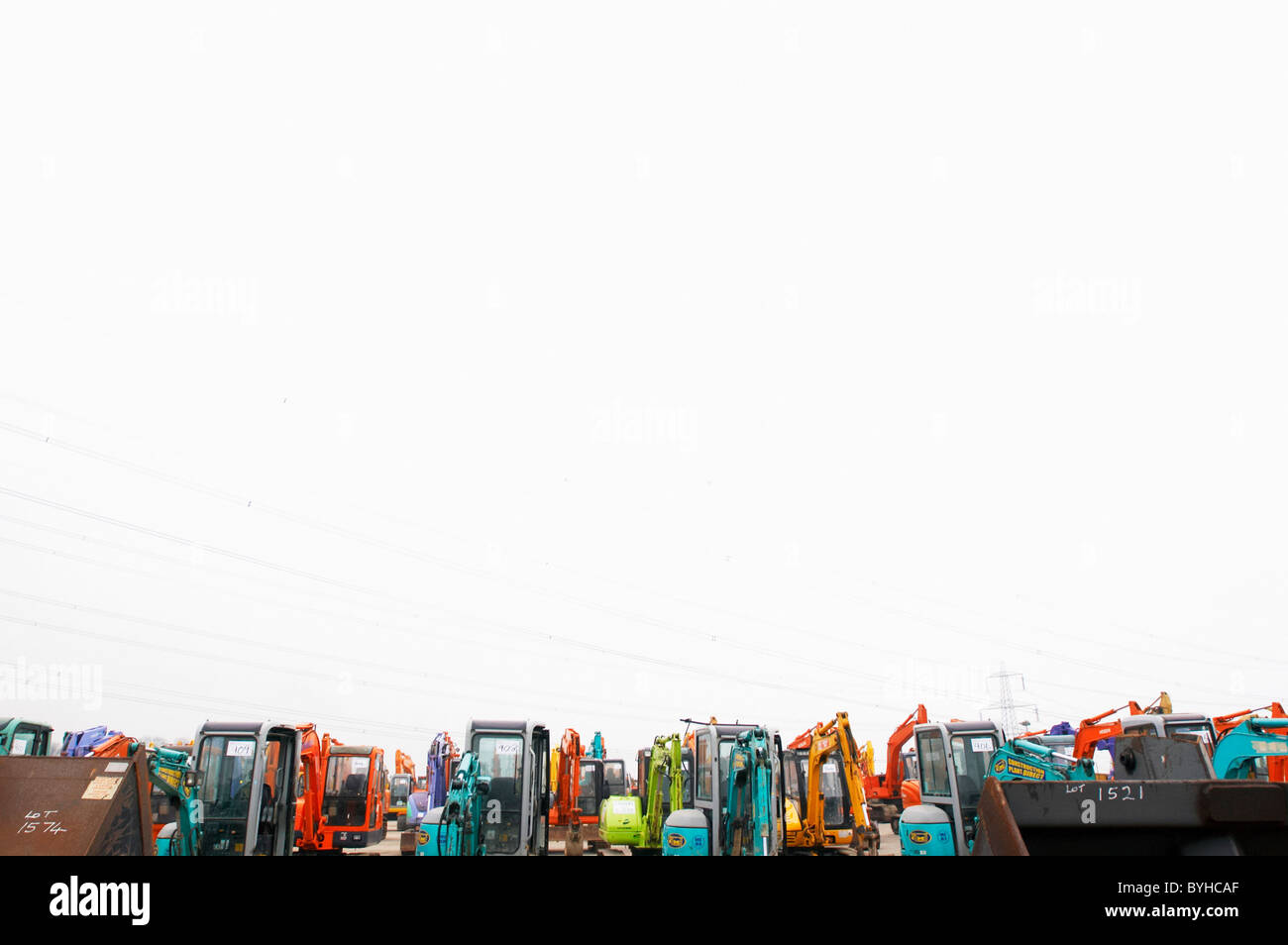 Mini-diggers lined up on a yard Stock Photo