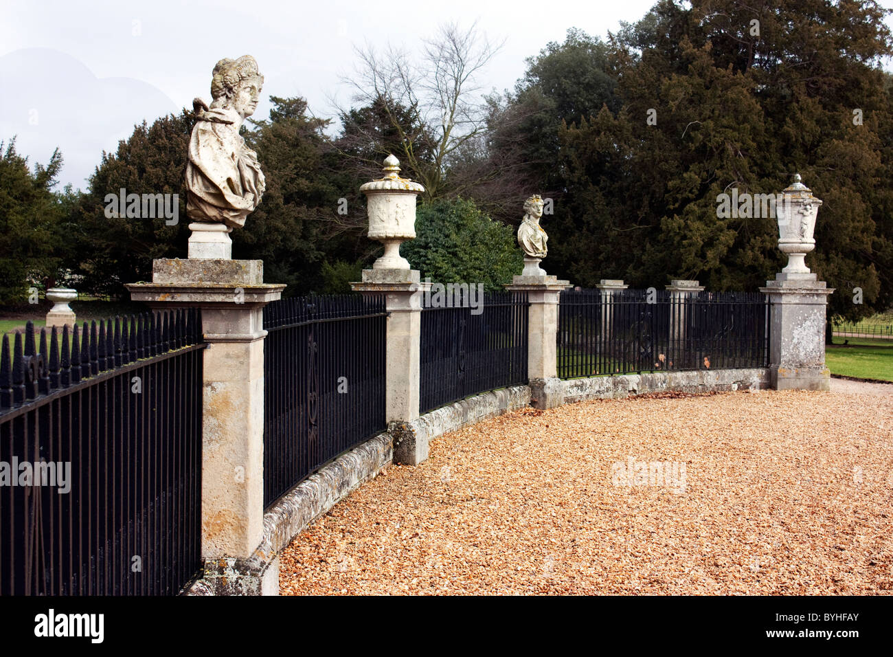old style statues or busts with iron railings at park Stock Photo