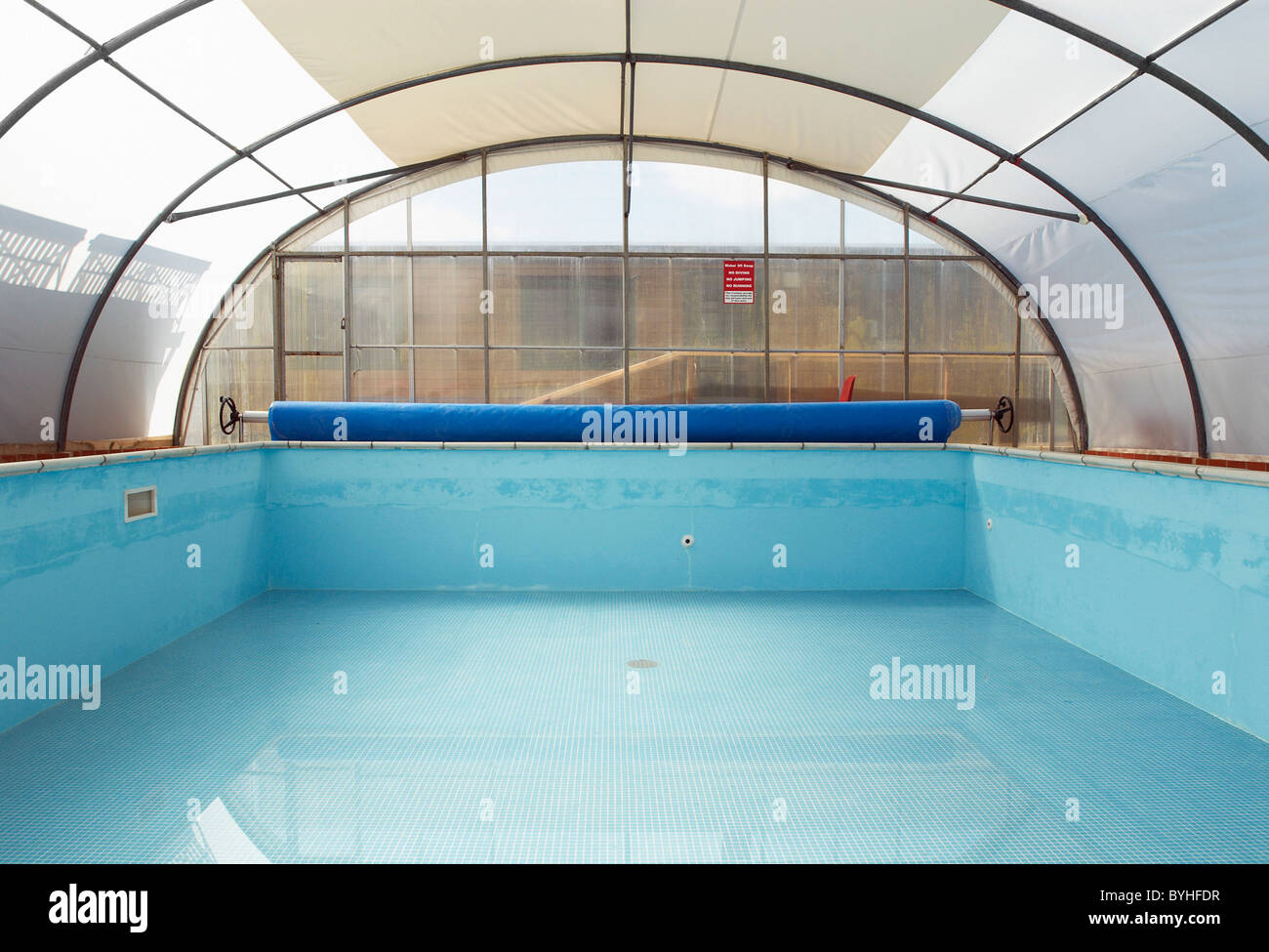 Empty swimming pool with polycarbonate roof Stock Photo - Alamy