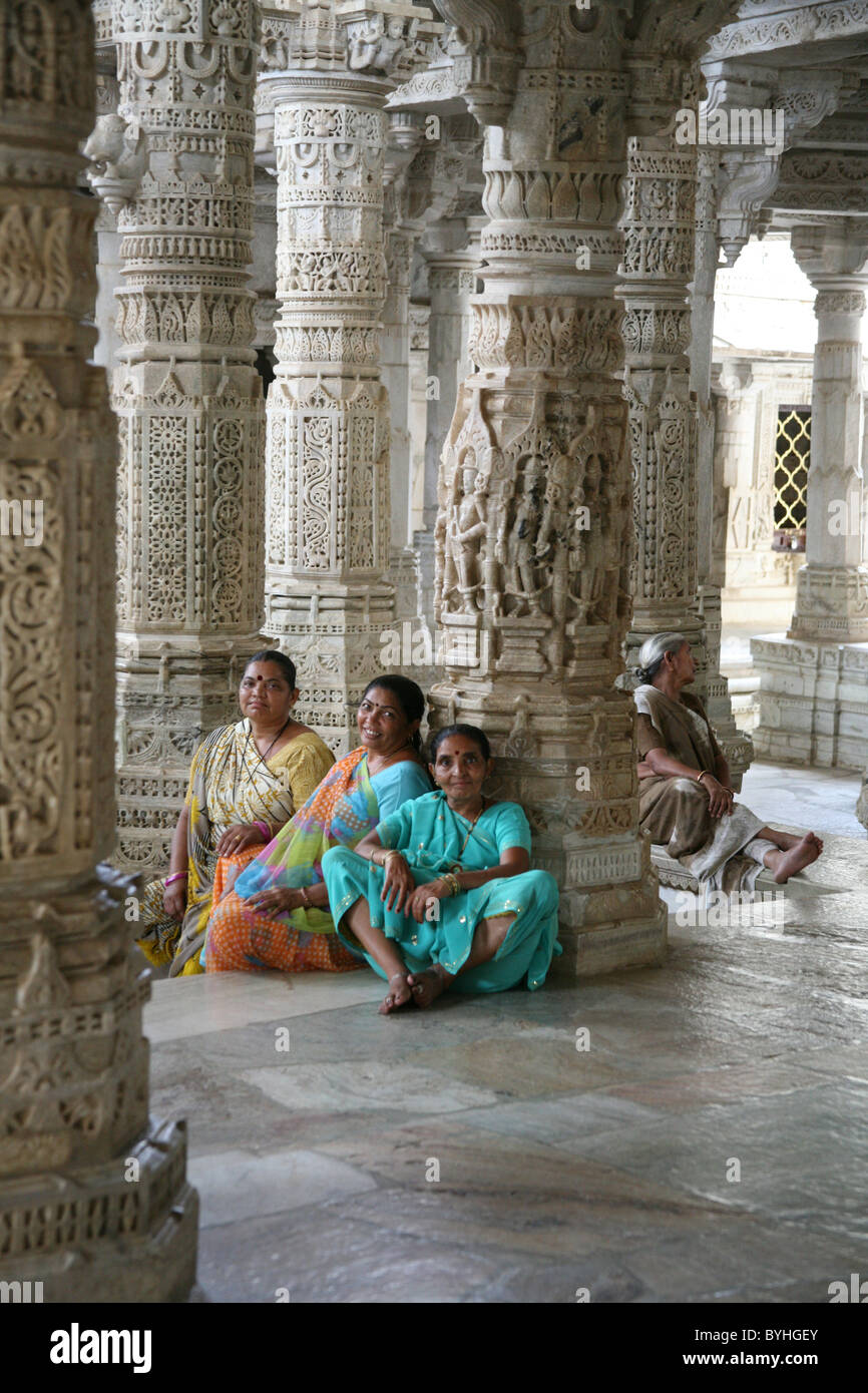 Women pilgrims resting at Jain marble Adishwar Chaumukha Mandir Temple, Ranakpur, Rajasthan Stock Photo