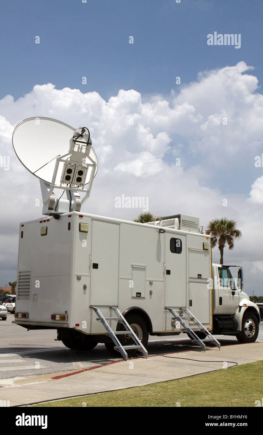 Parked satellite truck transmits breaking news events to orbiting satellites for broadcast around the world. Stock Photo