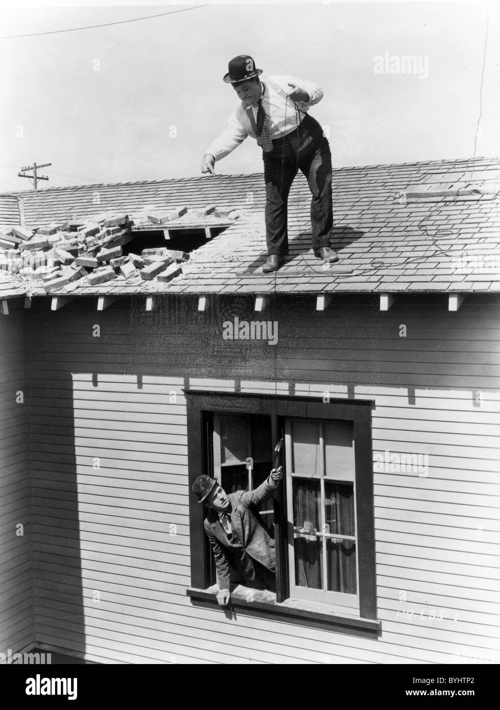 THE FINISHING TOUCH 1928 Hal Roach/MGM film with Oliver Hardy on the roof and Stan Laurel Stock Photo
