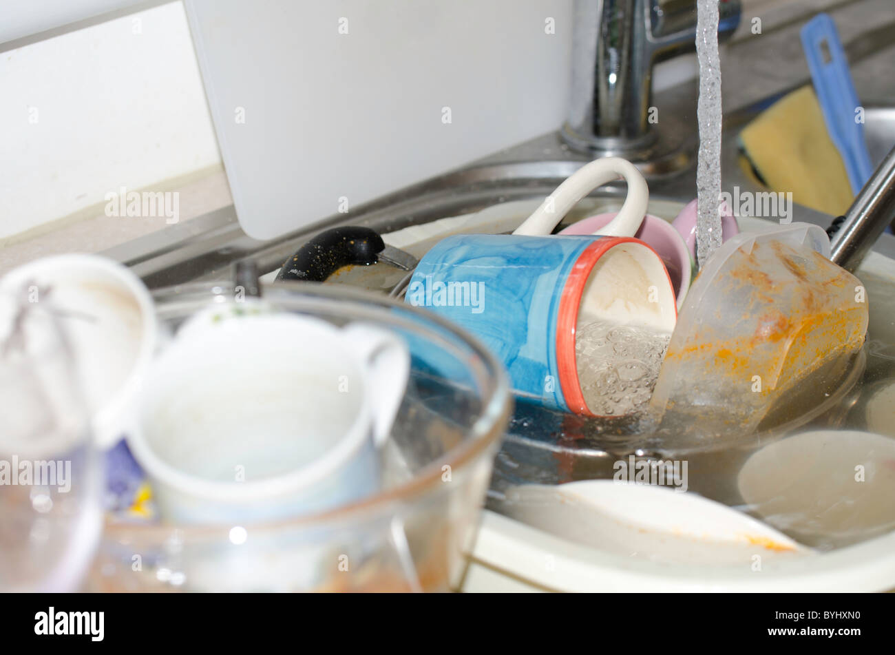 Kitchen sink full of dirty dishes Stock Photo Alamy