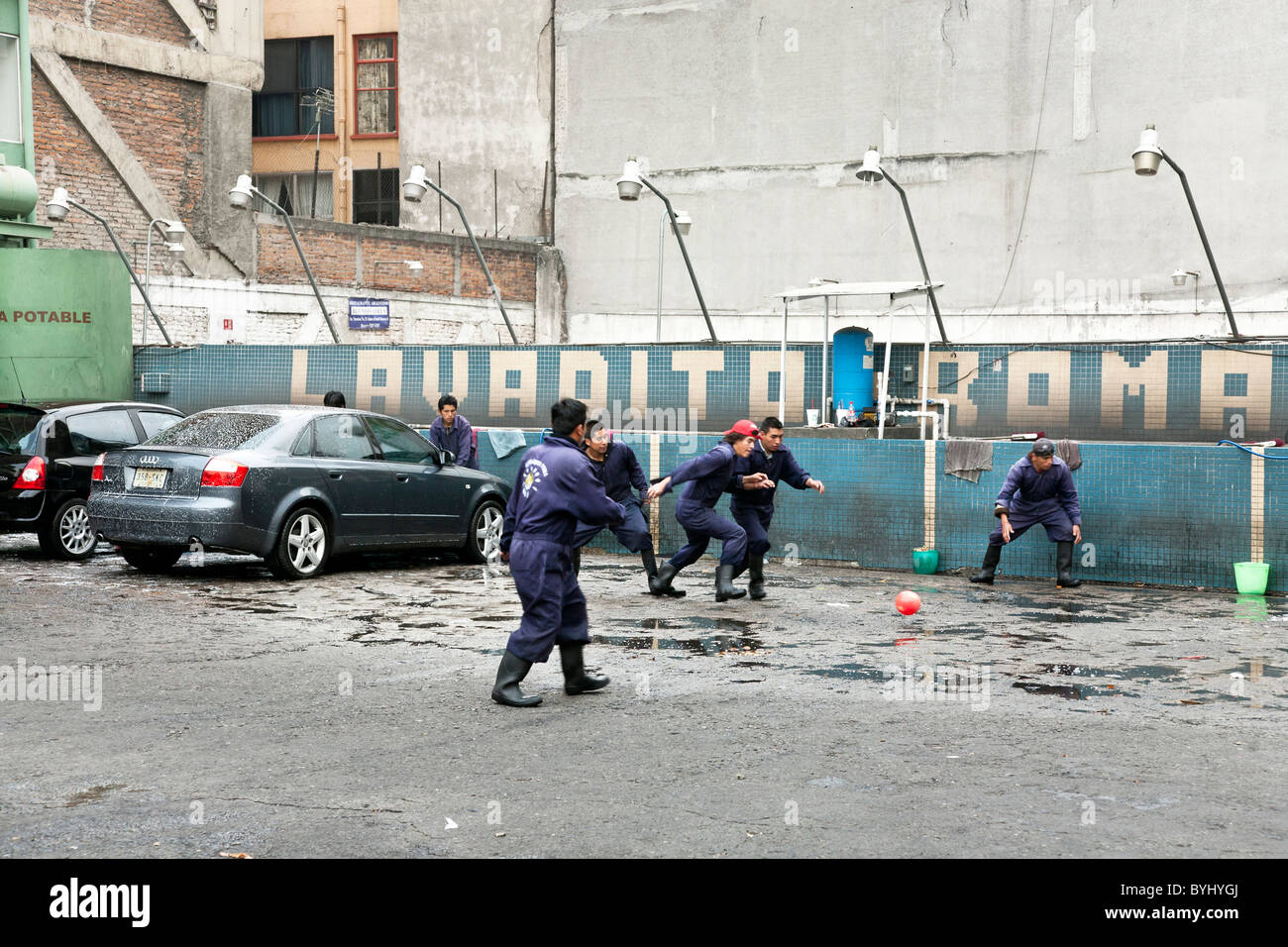 car wash workers play a game of pick up soccer on car wash lot Avenida Independencia Roma District Mexico City Stock Photo