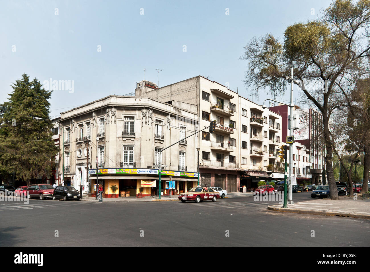 Avenida Alvaro Obregon with Belle Epoch style corner building next to Art Deco apartment structure Roma district Mexico City Stock Photo