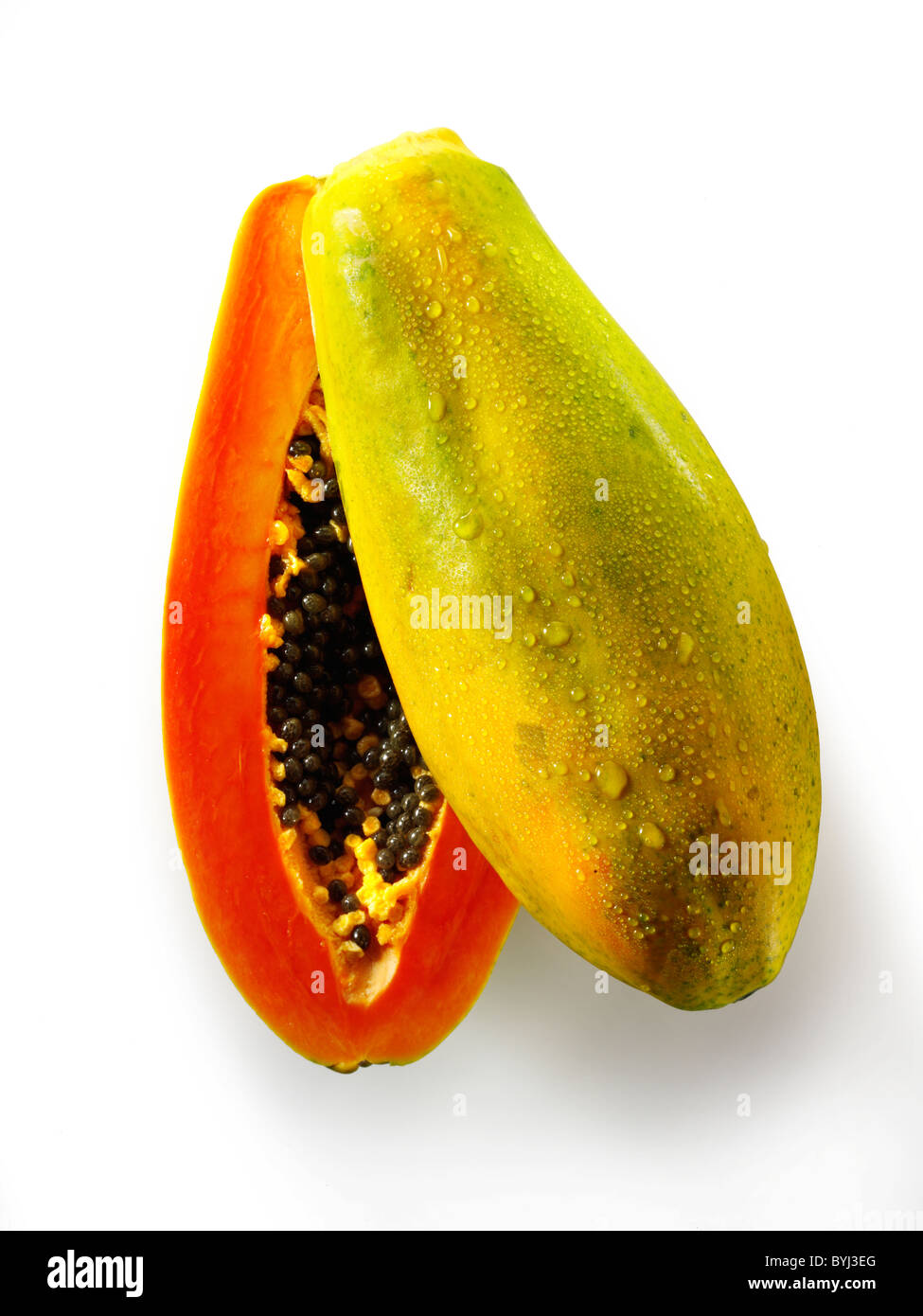 Fresh Formosa papaya cut, against a white background as a cut out Stock Photo