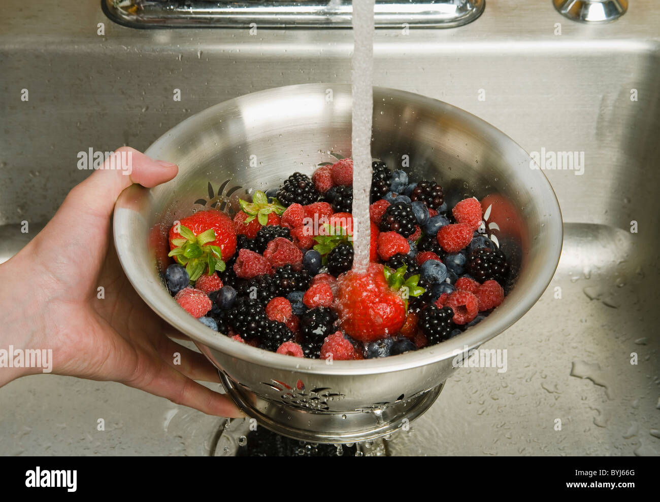 Fresh strawberries, red raspberries, blackberries and blueberries in a