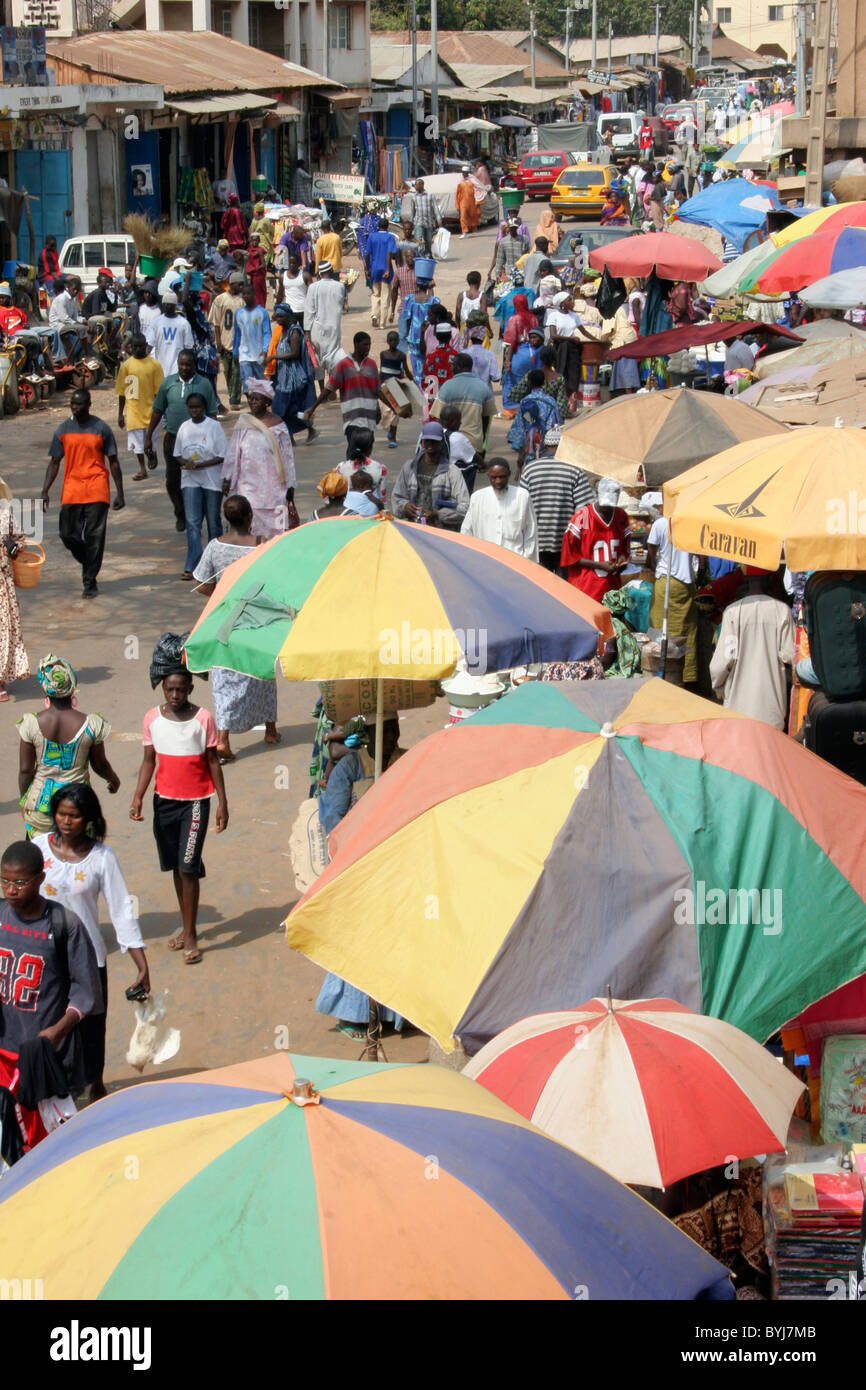 Bakau Market View of Serekunda's city main ground street with traffic, people, colors, stalls and shops. Stock Photo