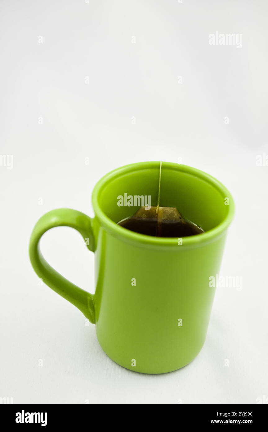 Green mug with tea in it Stock Photo