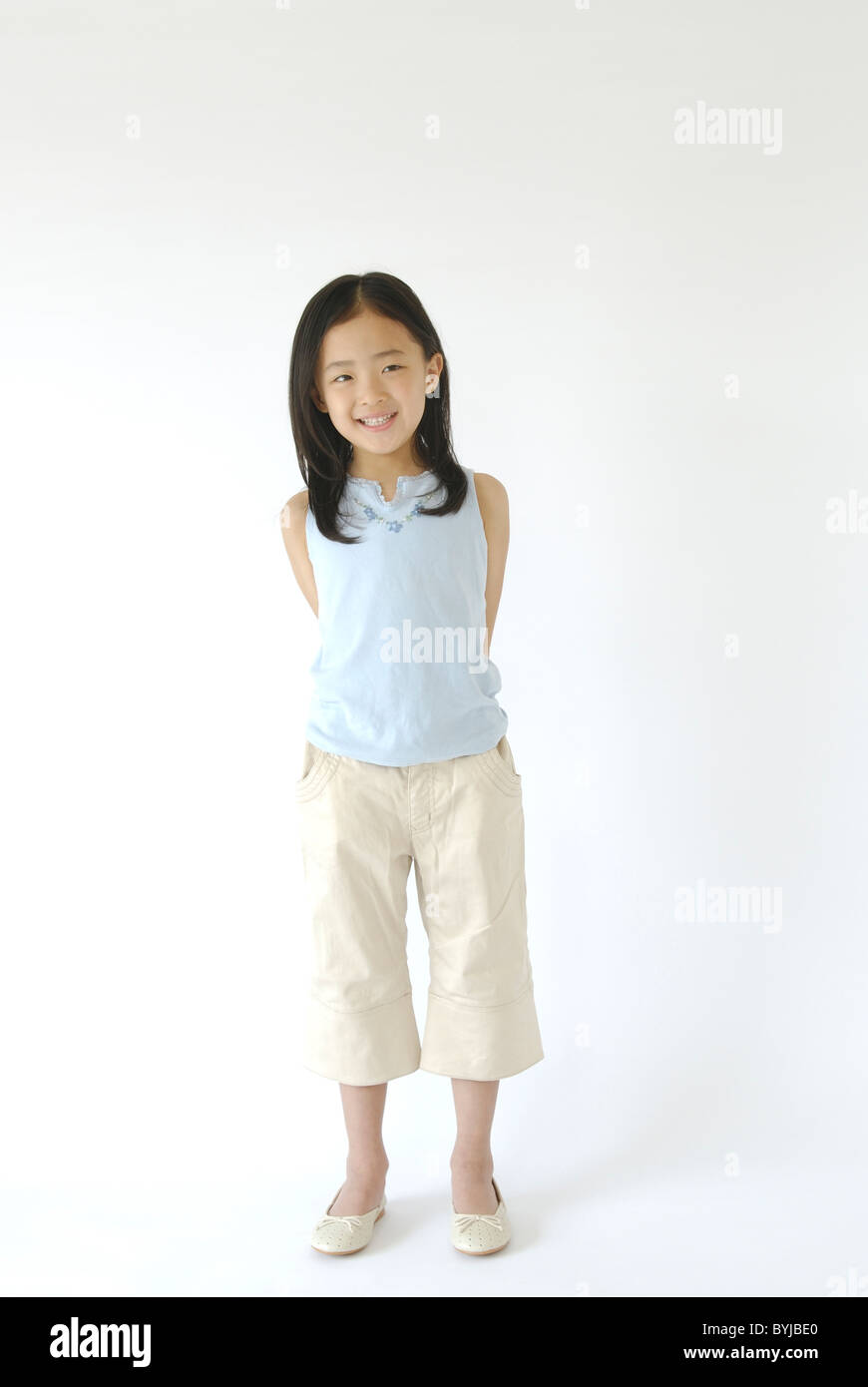 Girl Standing Portrait Looking At Camera Smiling Stock Photo - Alamy