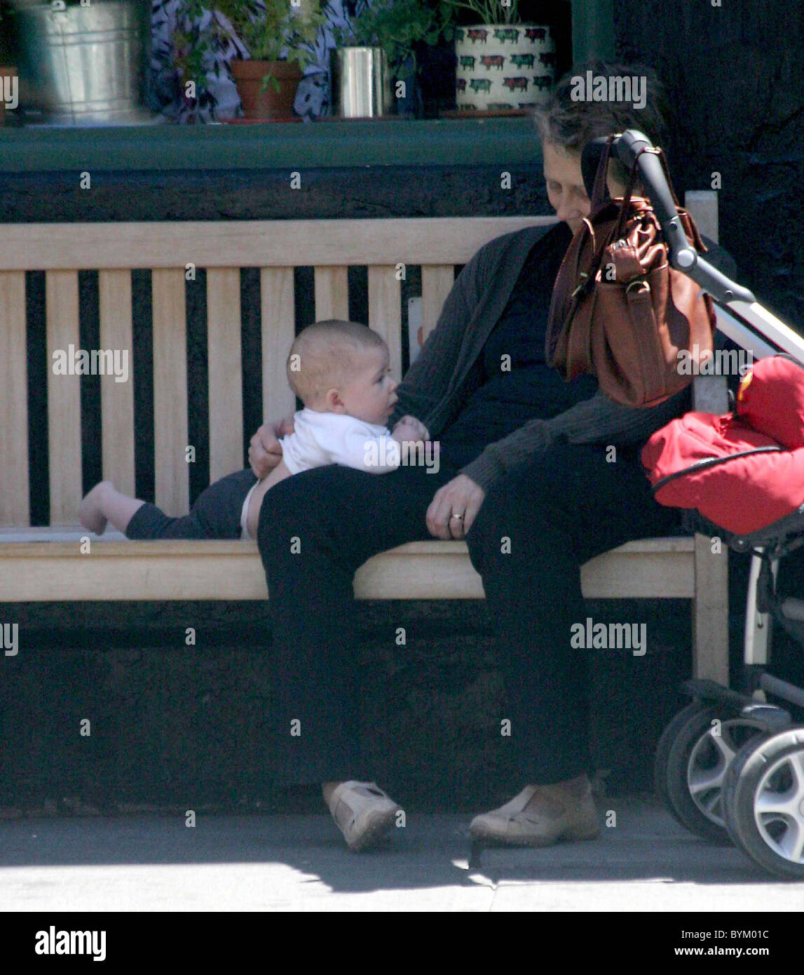 Maggie Gyllenhaal's daughter Ramona Sarsgaard plays with her grandmother Naomi Foner before lunch in the West Village New York Stock Photo