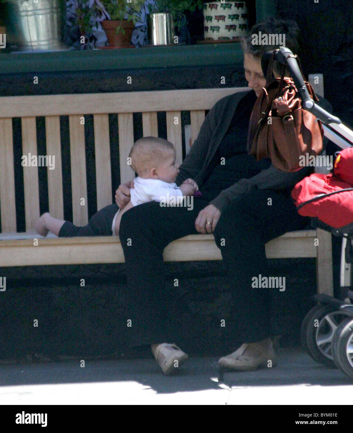 Maggie Gyllenhaal's daughter Ramona Sarsgaard plays with her grandmother Naomi Foner before lunch in the West Village New York Stock Photo