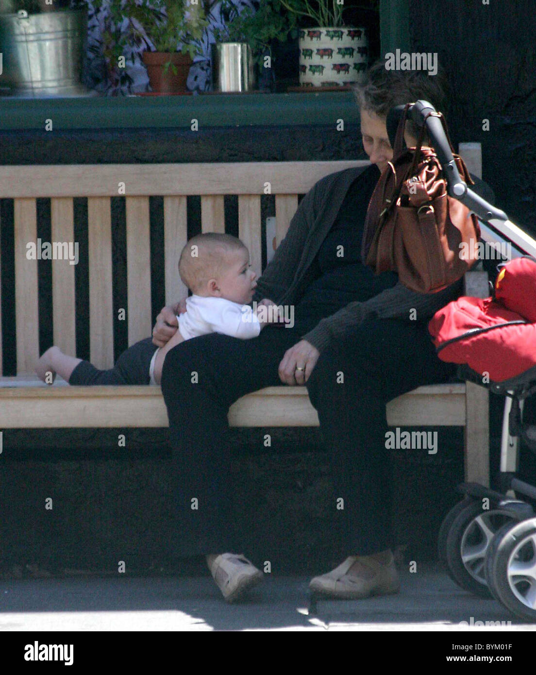 Maggie Gyllenhaal's daughter Ramona Sarsgaard plays with her grandmother Naomi Foner before lunch in the West Village New York Stock Photo