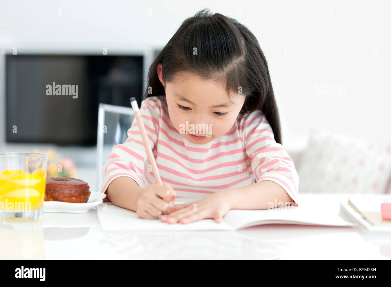 Girl doing homework Stock Photo - Alamy