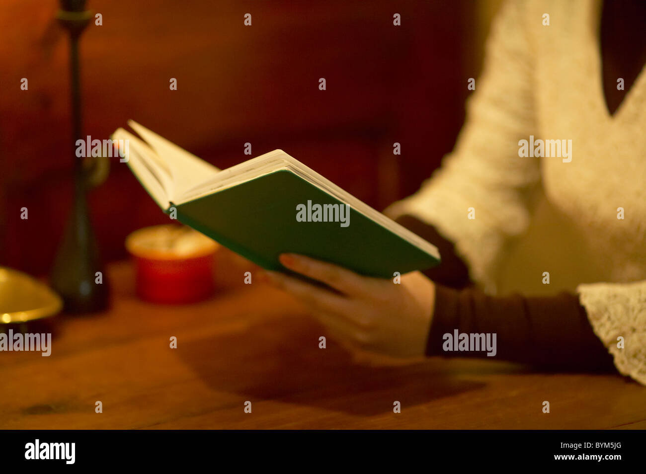 Woman Sitting Chair Table Holding Book Reading Stock Photo - Alamy