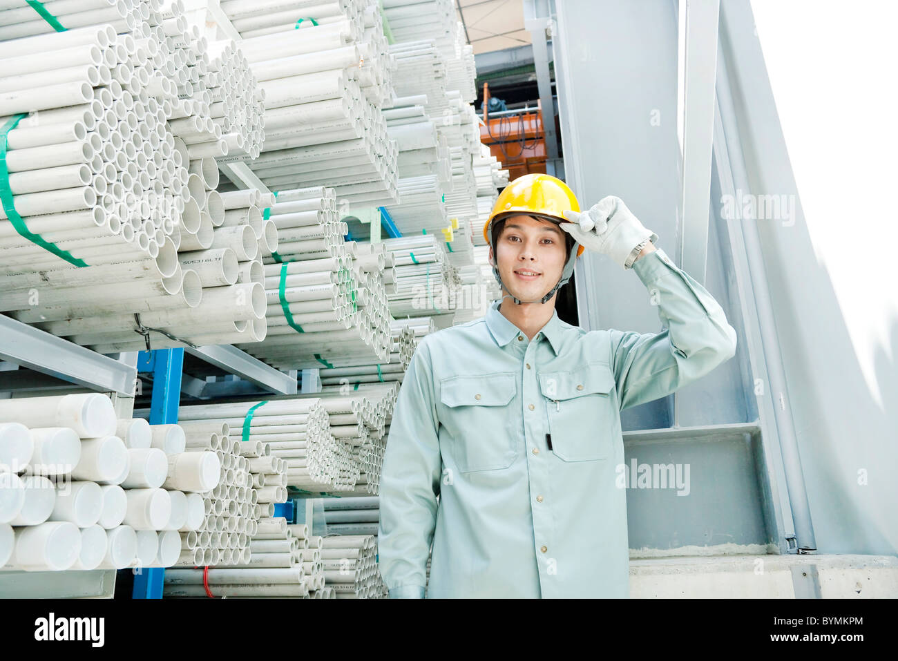 Warehouse worker tipping hardhat Stock Photo