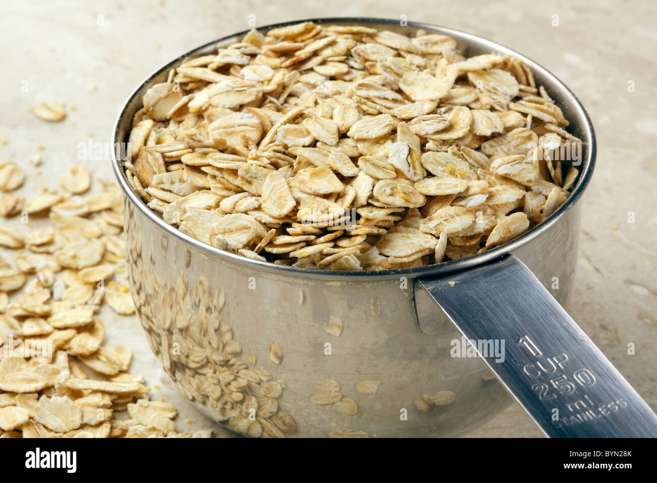 Oats in measuring cup Stock Photo