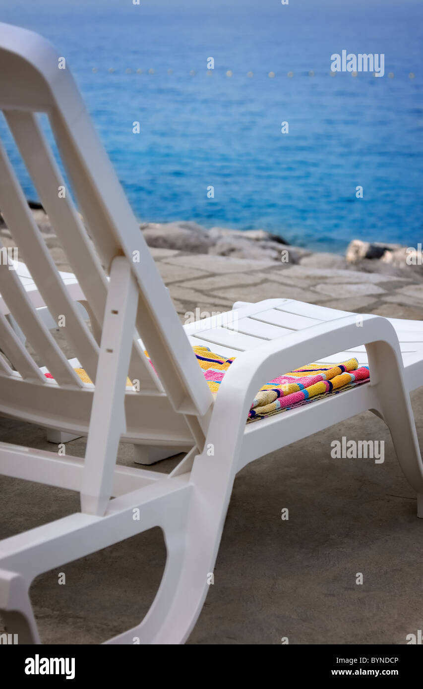 White deck chair on beach Stock Photo