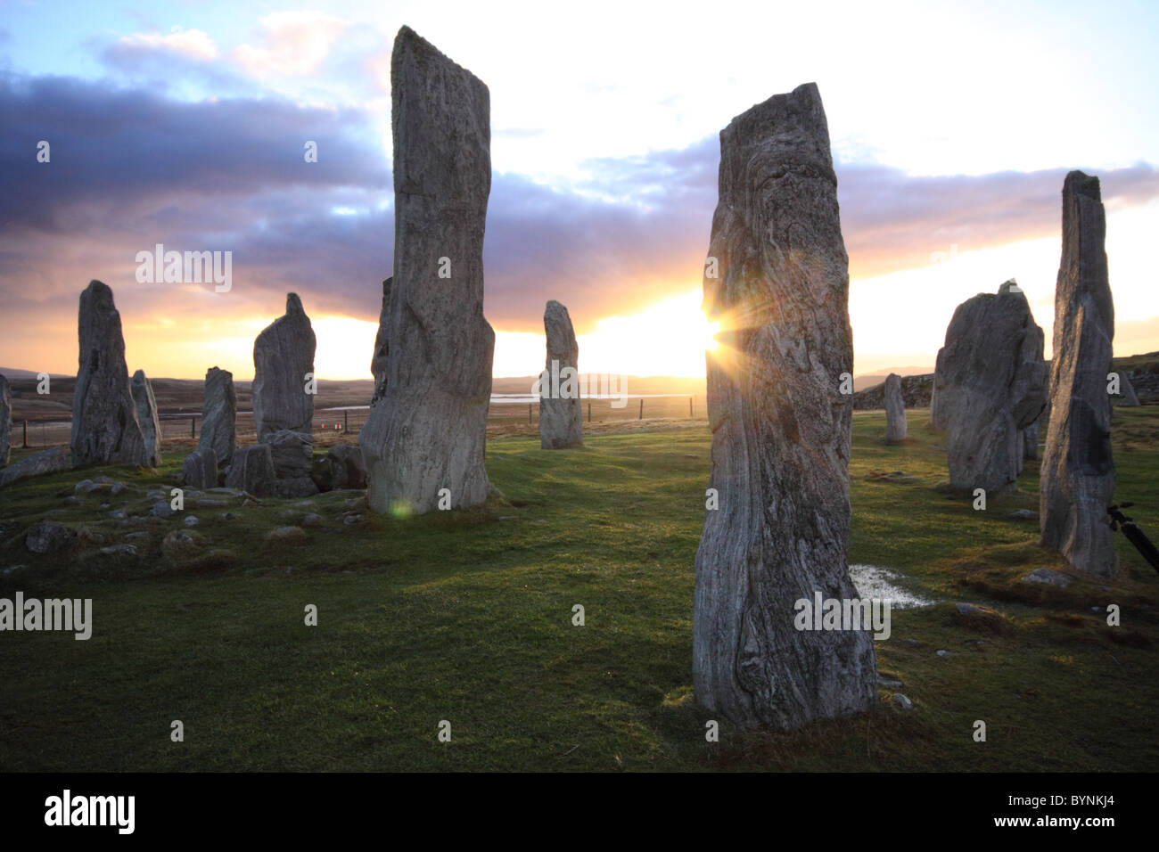 Callanish standing stones Isle of Lewis sunset sky atmospheric texture pattern historic silhouetted sun flare sparkle Stock Photo