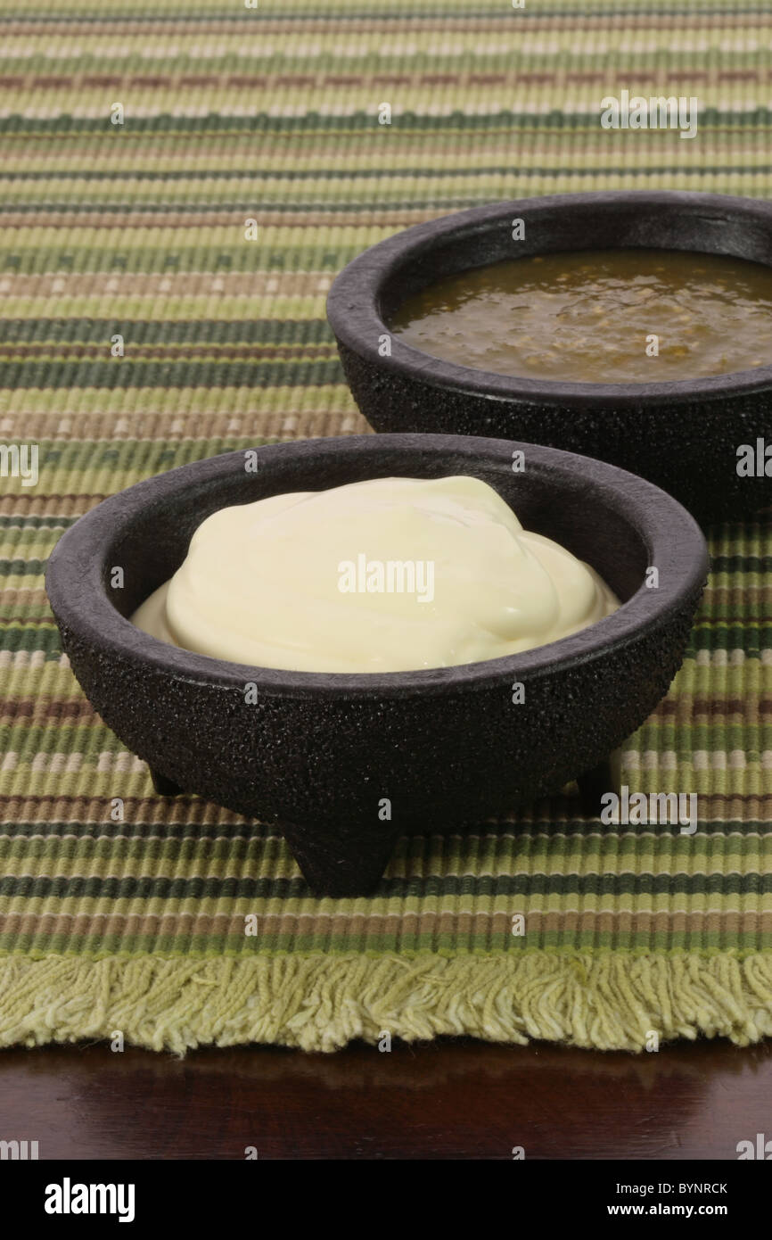 delicious sour cream and salsa verde or tomatillo sauce made with hot peppers and fresh tomatillos Stock Photo