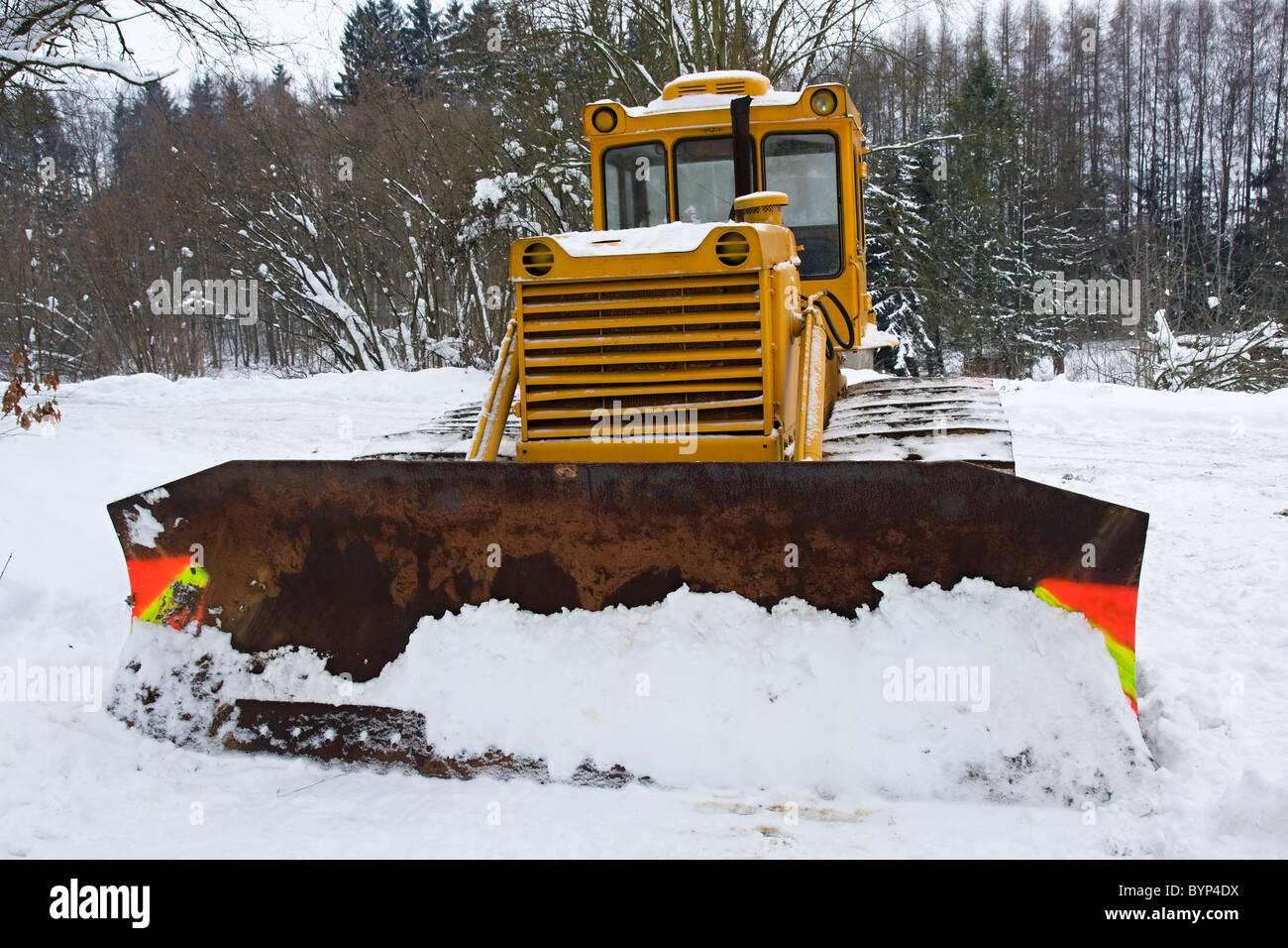 Bulldozer in the snow in winter Stock Photo