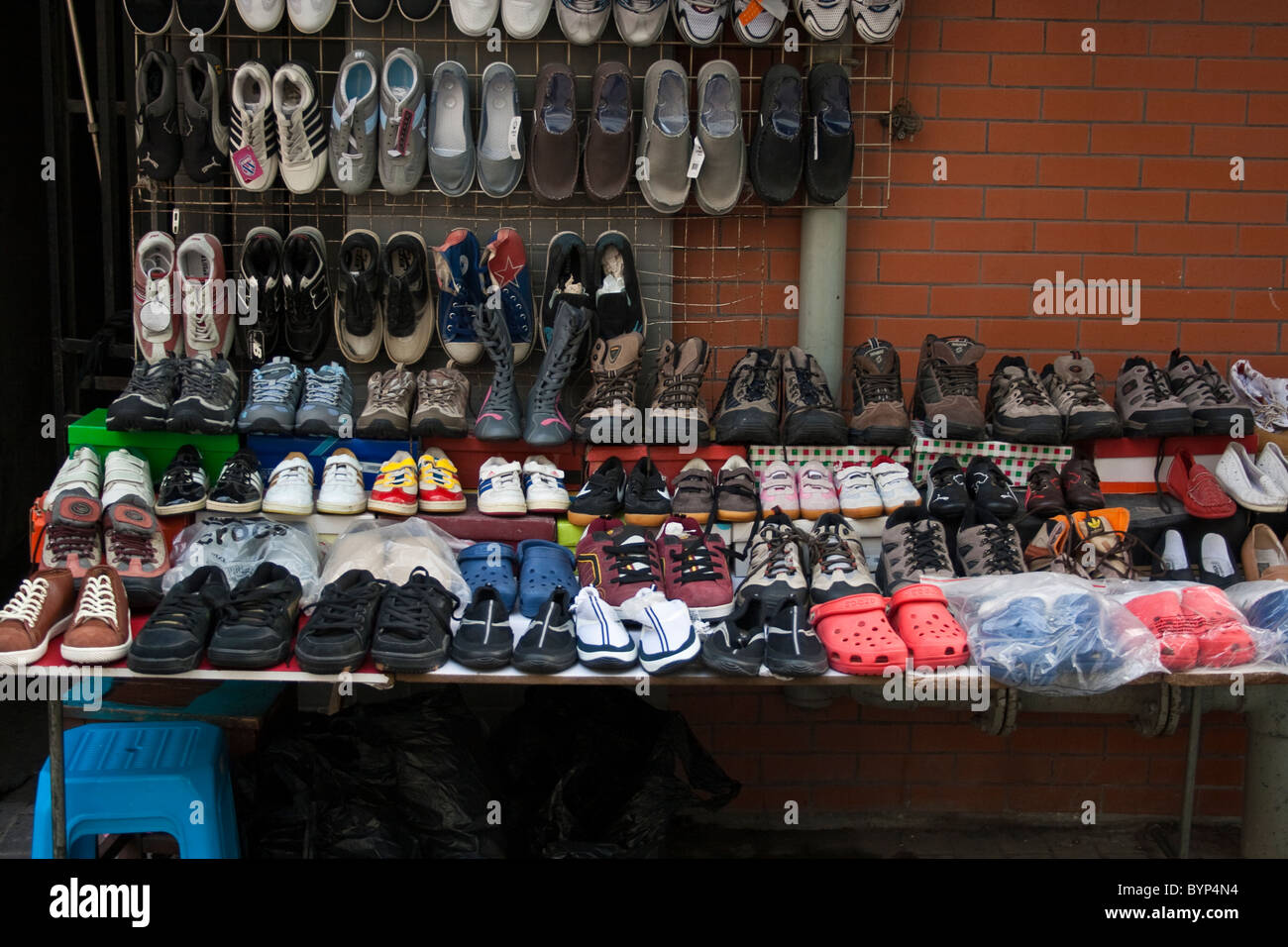 Shoes for sale on street market stall in Shanghai Stock Photo - Alamy