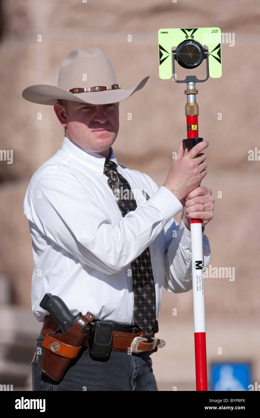 Texas Ranger holds GPS survey marking equipment to gather evidence