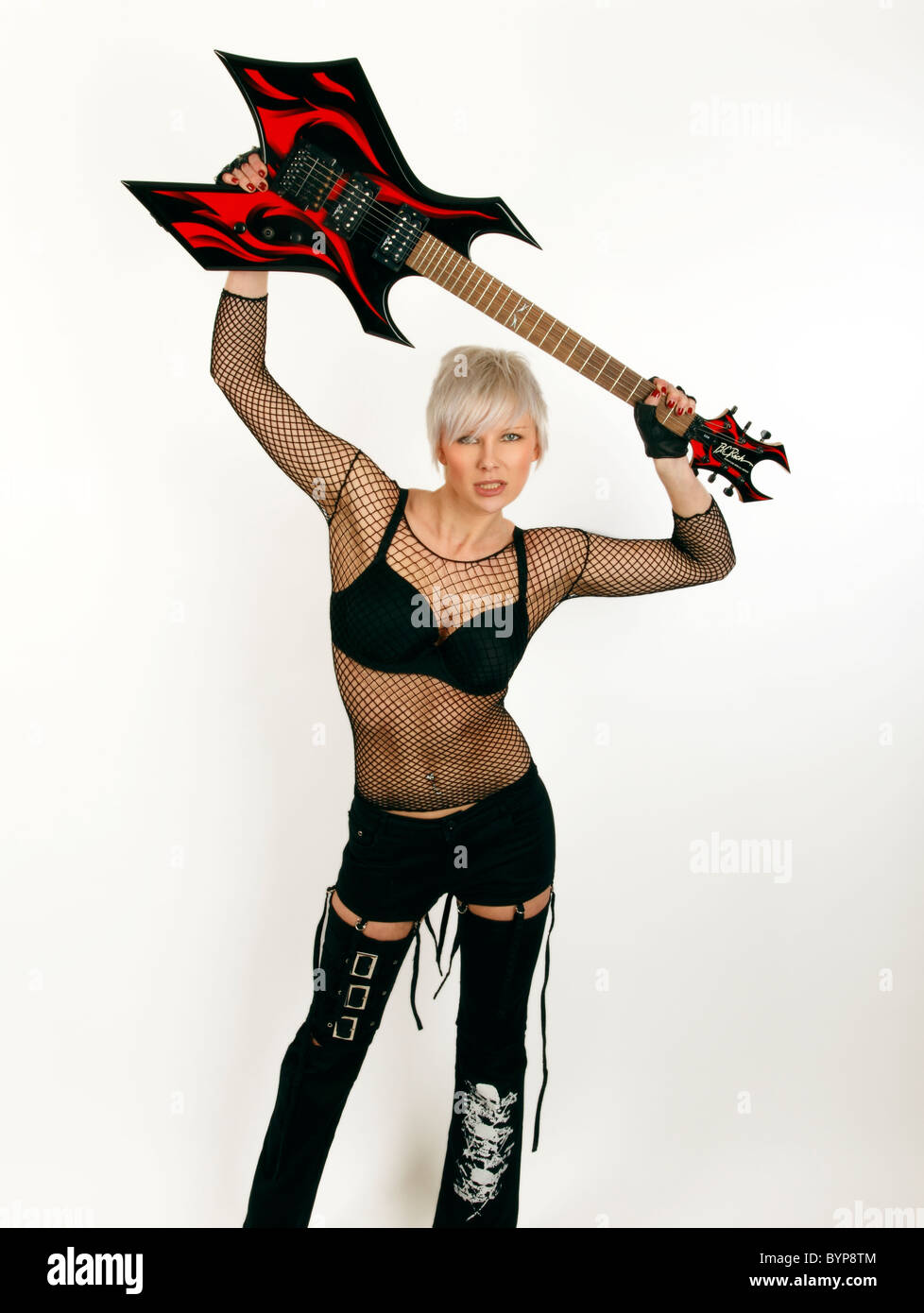 rock chick holding a warlock heavy metal guitar Stock Photo