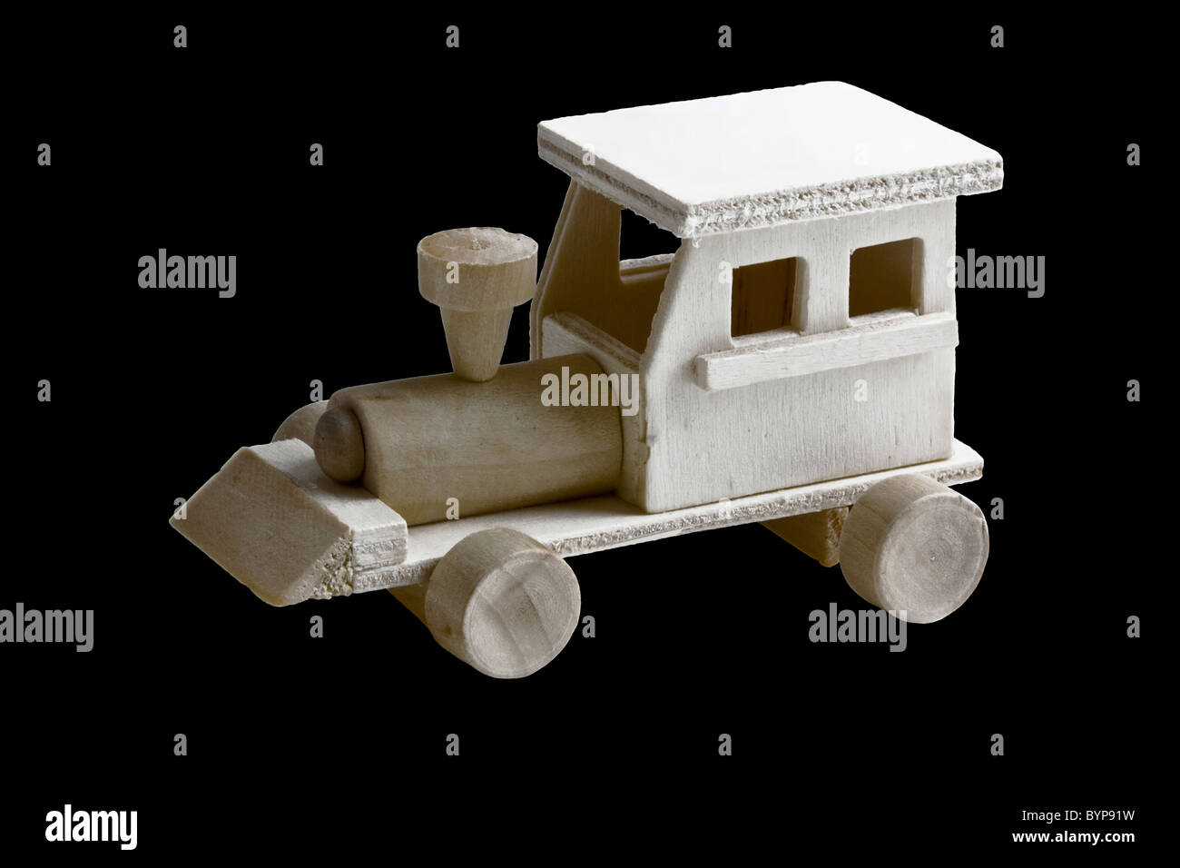 Wooden toy toy with wheels on black background Stock Photo