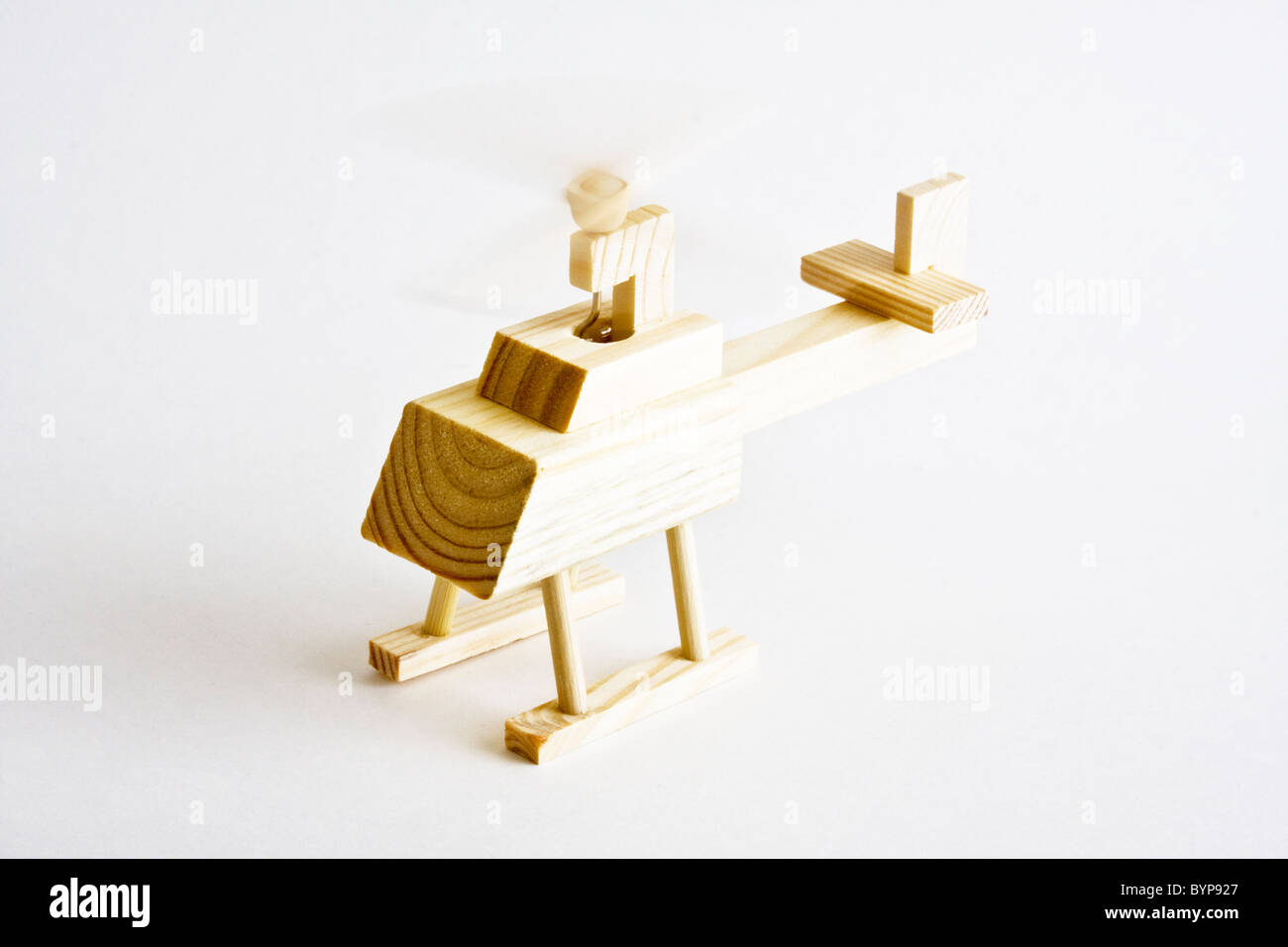 Wooden toy helicopter with spinning blade on white background Stock Photo