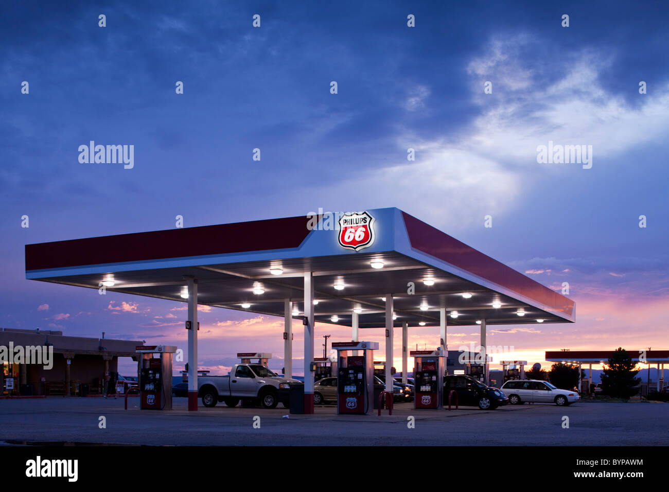USA, New Mexico, Santa Fe, Sunset lights sky behind Phillips 66 Gas