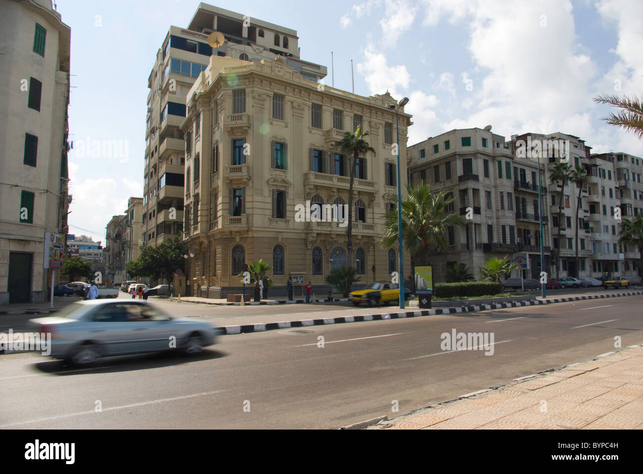 Car racing past apartments in Alexandria Stock Photo Alamy