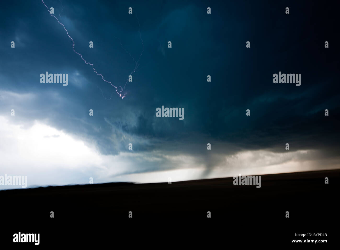 USA, South Dakota, Blurred image of lightning striking within dark clouds of summer thunderstorm on prairie Stock Photo
