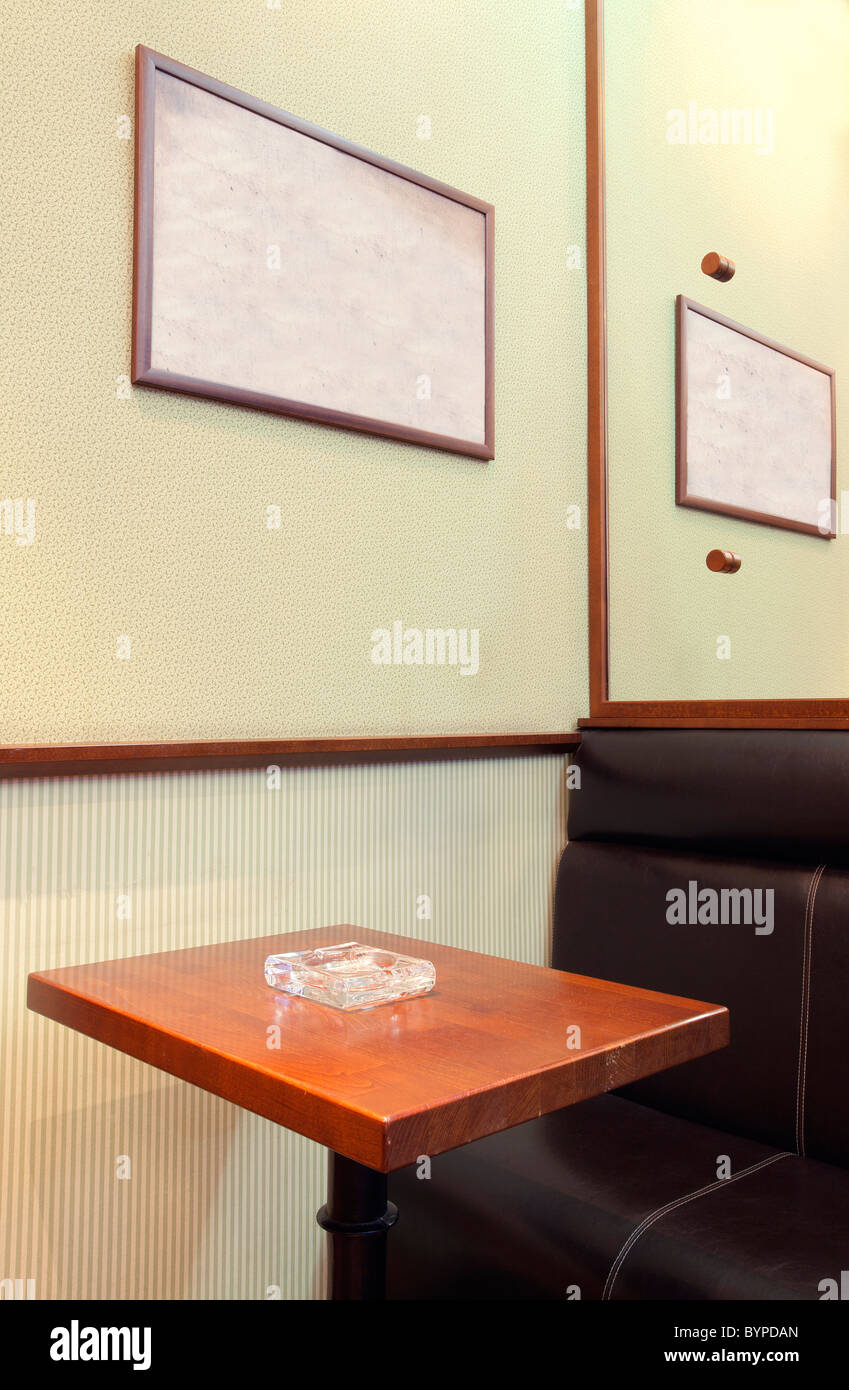Details of an interior of a small cafe. Just chairs, empty frames and