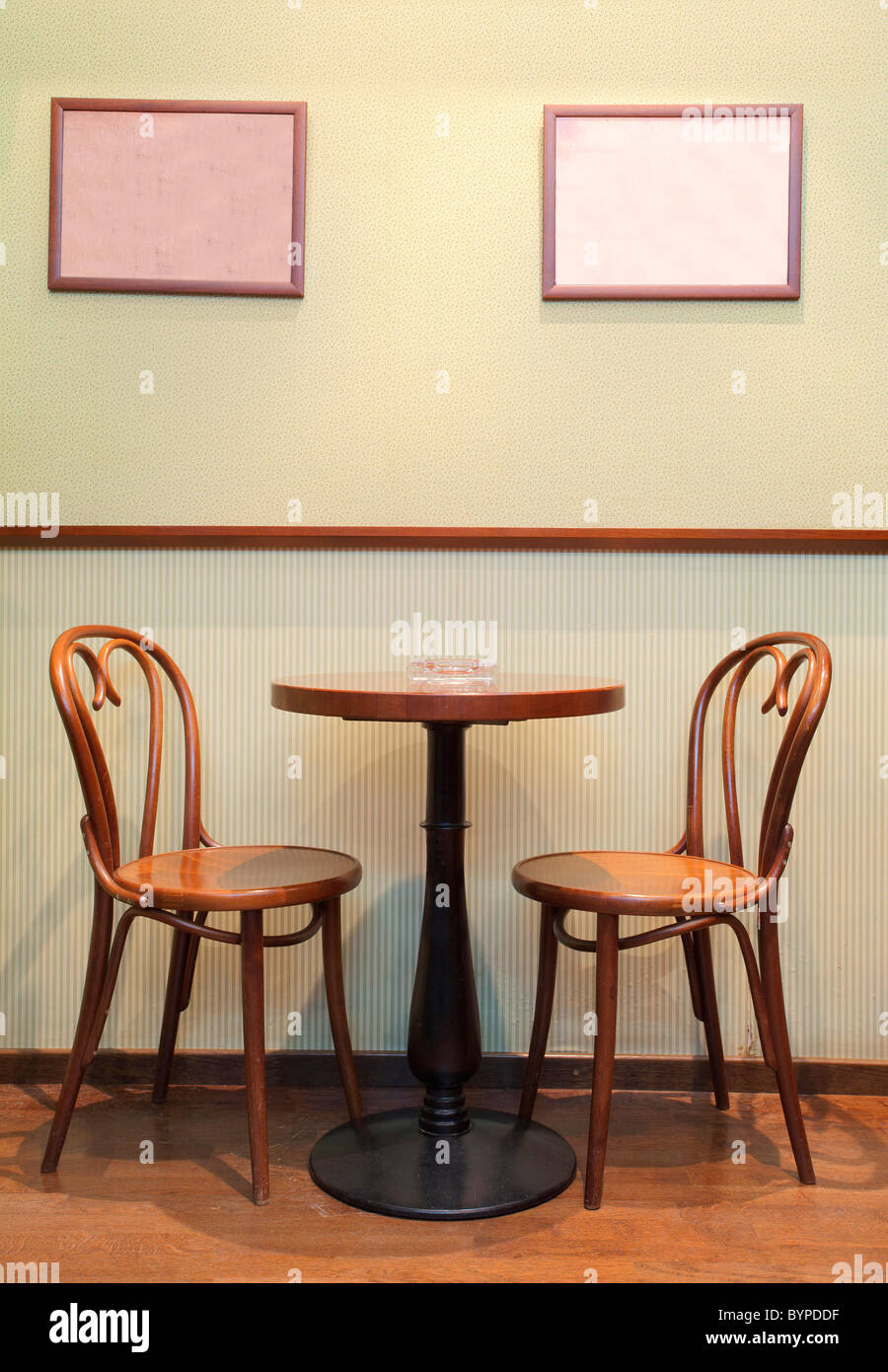 Details of an interior of a small cafe. Just chairs, empty frames and