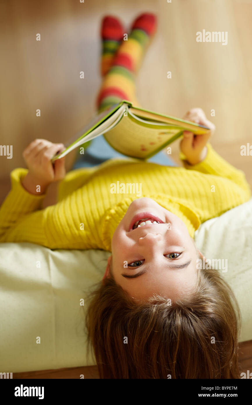 girl-lying-on-bed-and-reading-book-stock-photo-alamy