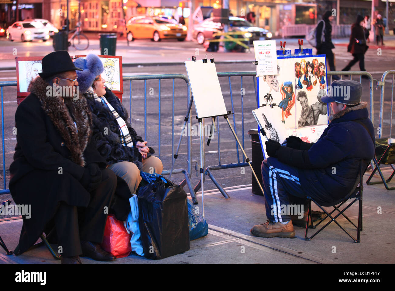 Tourists having portrait taken by street caricature artist in Times square, New york city, December 2010 Stock Photo